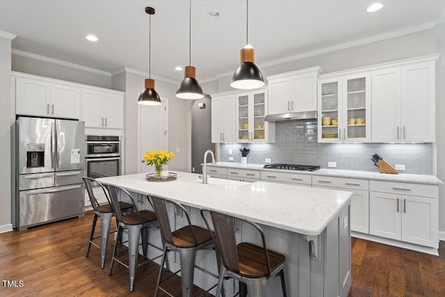 213 Preatonwood Dr, Apex, NC 27539 - kitchen with stainless steel appliances, a sink, a kitchen breakfast bar, white cabinets, and ornamental molding