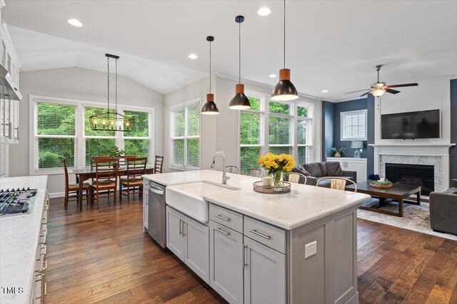 213 Preatonwood Dr, Apex, NC 27539 - kitchen featuring a sink, stainless steel appliances, dark wood finished floors, a fireplace, and ceiling fan
