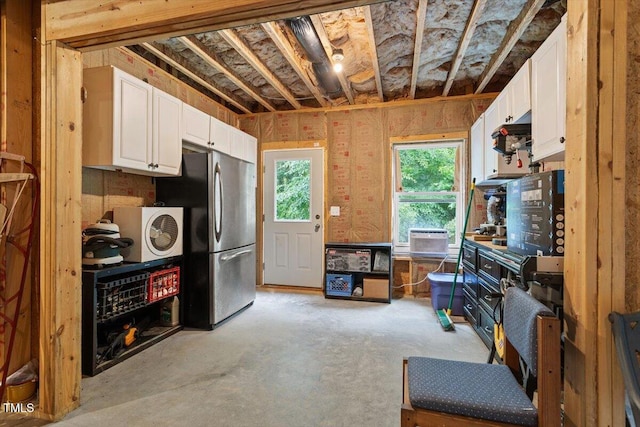213 Preatonwood Dr, Apex, NC 27539 - kitchen featuring freestanding refrigerator, white cabinets, unfinished concrete flooring, and cooling unit