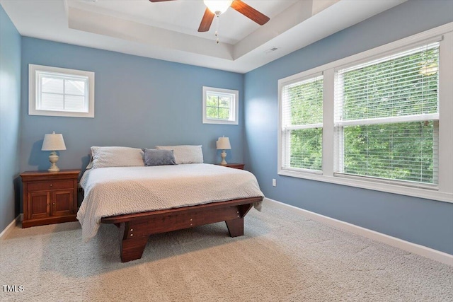 213 Preatonwood Dr, Apex, NC 27539 - carpeted bedroom featuring baseboards, a raised ceiling, and a ceiling fan