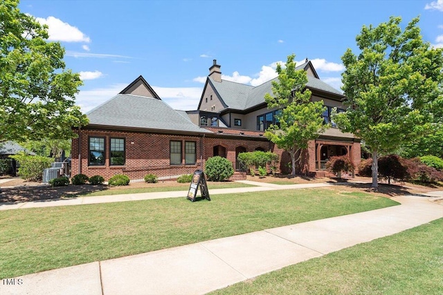 213 Preatonwood Dr, Apex, NC 27539 - view of front facade with a front lawn, brick siding, a chimney, and central air condition unit
