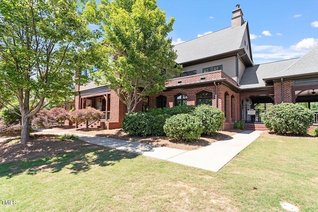 213 Preatonwood Dr, Apex, NC 27539 - view of front facade with brick siding, a front lawn, and a chimney