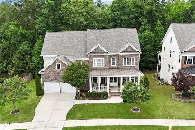 213 Preatonwood Dr, Apex, NC 27539 - view of front of house with a porch, concrete driveway, a front yard, brick siding, and an attached garage