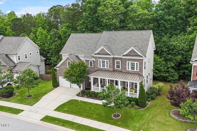 213 Preatonwood Dr, Apex, NC 27539 - view of front facade featuring a porch, a standing seam roof, concrete driveway, and a front lawn