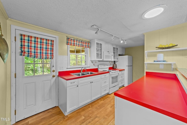 205 W Oak Ave, Wake Forest, NC 27587 - kitchen with white appliances, a sink, rail lighting, white cabinetry, and a textured ceiling