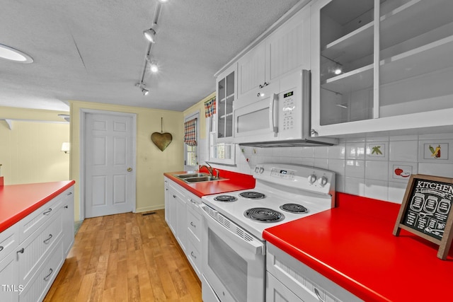 205 W Oak Ave, Wake Forest, NC 27587 - kitchen featuring white appliances, a sink, white cabinetry, and a textured ceiling