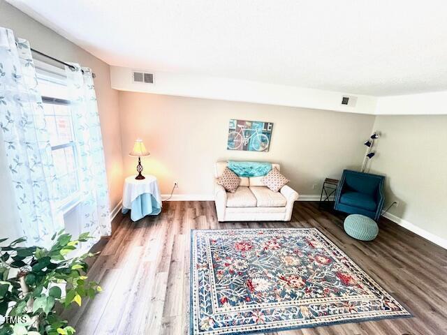 141 Jones Franklin Rd Unit G, Raleigh, NC 27606 - living area featuring wood finished floors and baseboards