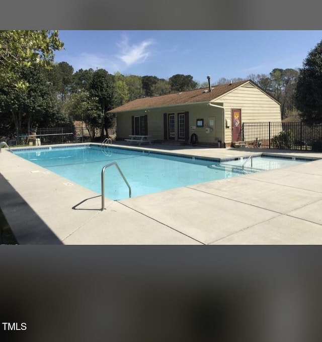 141 Jones Franklin Rd Unit G, Raleigh, NC 27606 - community pool featuring a patio area and view of scattered trees