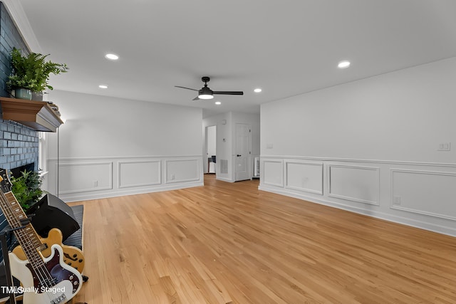 4259 Old Faison Rd, Knightdale, NC 27545 - unfurnished living room with a decorative wall, ceiling fan, a fireplace, recessed lighting, and light wood-style floors