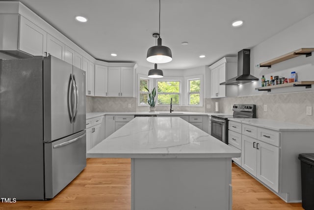 4259 Old Faison Rd, Knightdale, NC 27545 - kitchen featuring appliances with stainless steel finishes, wall chimney exhaust hood, a sink, a center island, and white cabinetry