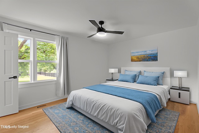 4259 Old Faison Rd, Knightdale, NC 27545 - bedroom featuring multiple windows, light wood-style flooring, and a ceiling fan