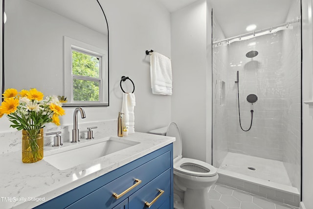4259 Old Faison Rd, Knightdale, NC 27545 - bathroom with vanity, toilet, a tile shower, and tile patterned flooring
