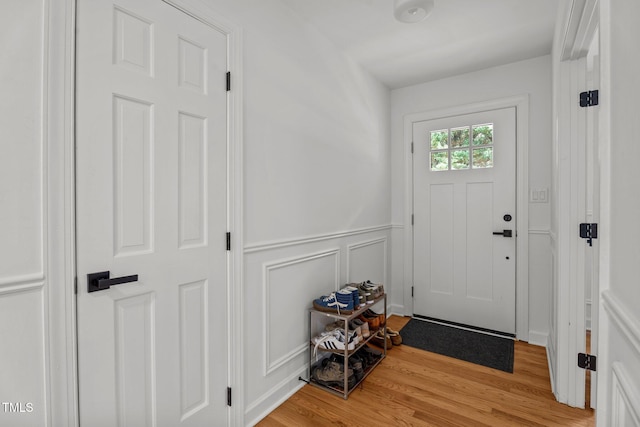 4259 Old Faison Rd, Knightdale, NC 27545 - entryway with light wood finished floors, a wainscoted wall, and a decorative wall
