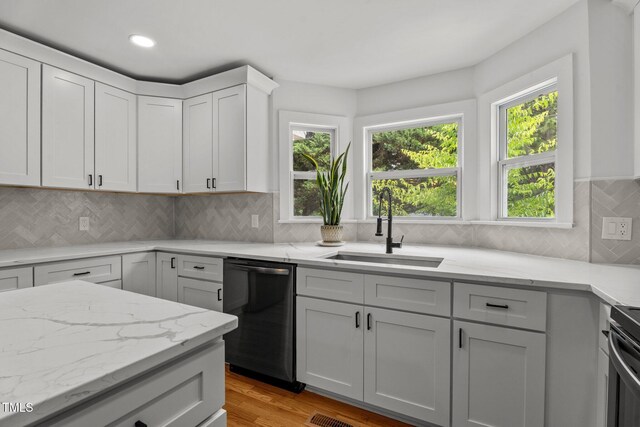 4259 Old Faison Rd, Knightdale, NC 27545 - kitchen featuring dishwasher, a sink, light wood finished floors, light stone countertops, and backsplash