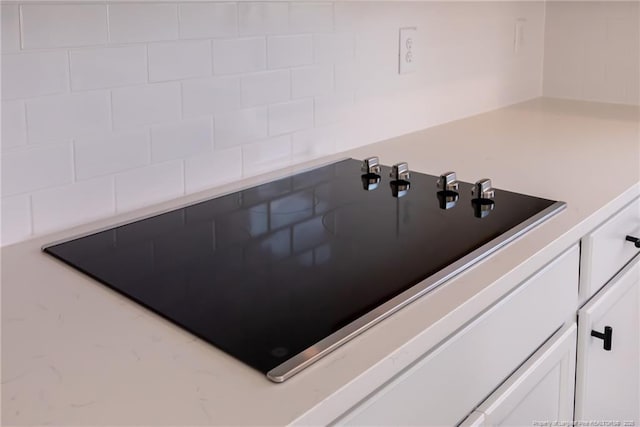 00 John B Carter Rd, Fayetteville, NC 28312 - kitchen view of black electric stovetop, white cabinetry, decorative backsplash, and light countertops