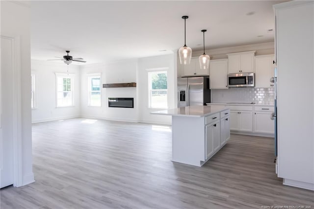 00 John B Carter Rd, Fayetteville, NC 28312 - kitchen with stainless steel appliances, healthy amount of natural light, a center island, white cabinetry, and crown molding