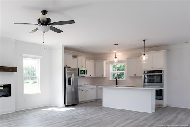 00 John B Carter Rd, Fayetteville, NC 28312 - kitchen with appliances with stainless steel finishes, light countertops, white cabinets, and light wood-type flooring