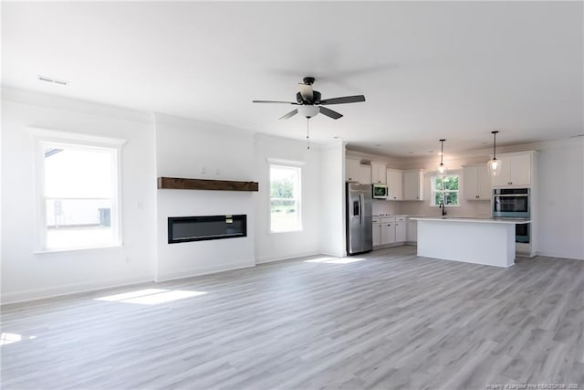 00 John B Carter Rd, Fayetteville, NC 28312 - unfurnished living room with a glass covered fireplace, ceiling fan, light wood-style floors, a sink, and baseboards
