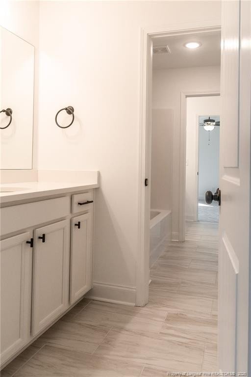 00 John B Carter Rd, Fayetteville, NC 28312 - bathroom with baseboards, vanity, tile patterned floors, and a tub to relax in