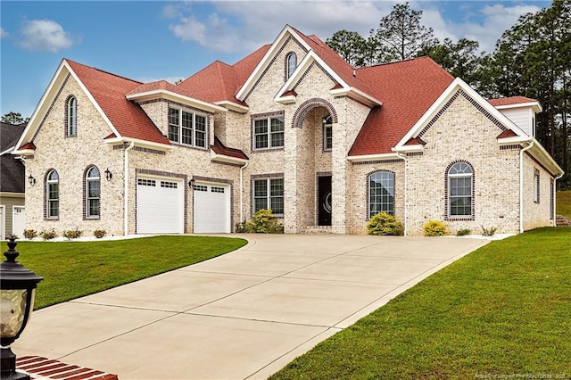 609 W Summerchase Dr, Fayetteville, NC 28311 - french provincial home featuring driveway, a front yard, a garage, and brick siding