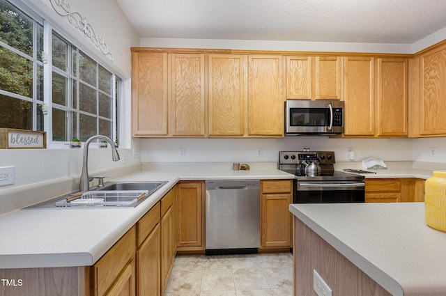 109 Troyer Pl, Apex, NC 27502 - kitchen featuring stainless steel appliances, a sink, light countertops, and light tile patterned floors
