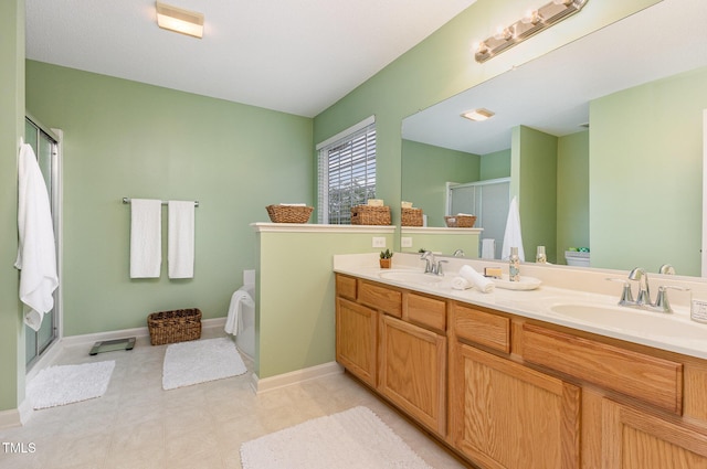 109 Troyer Pl, Apex, NC 27502 - bathroom with a shower stall, double vanity, tile patterned floors, baseboards, and toilet