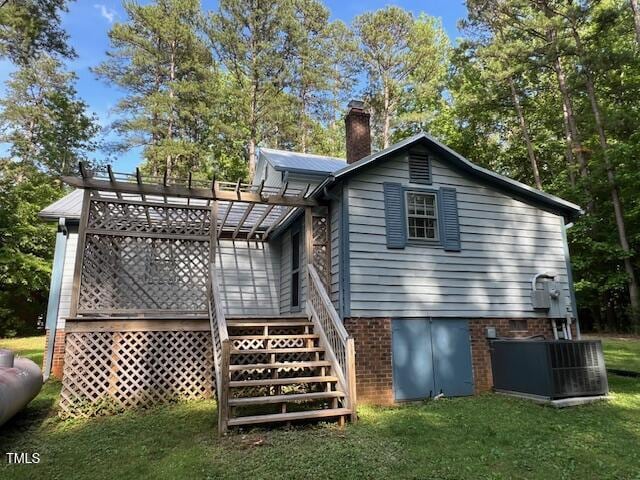 358 Pool Rock Shores Ln, Henderson, NC 27537 - back of property featuring cooling unit, a pergola, a chimney, a yard, and stairway