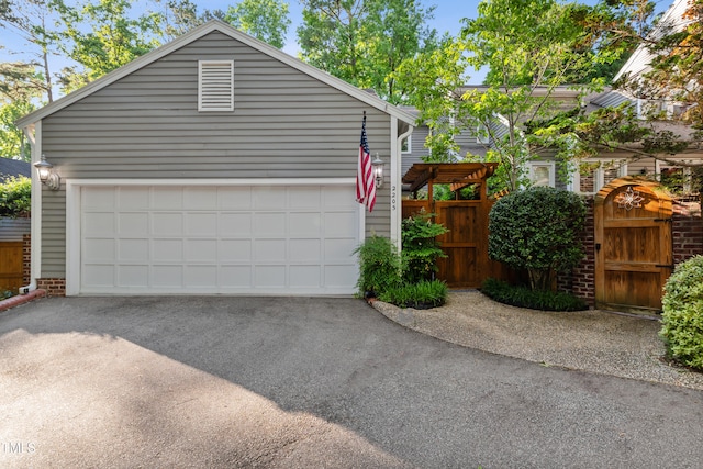 2205 Landings Way, Raleigh, NC 27615 - garage featuring a gate and asphalt driveway