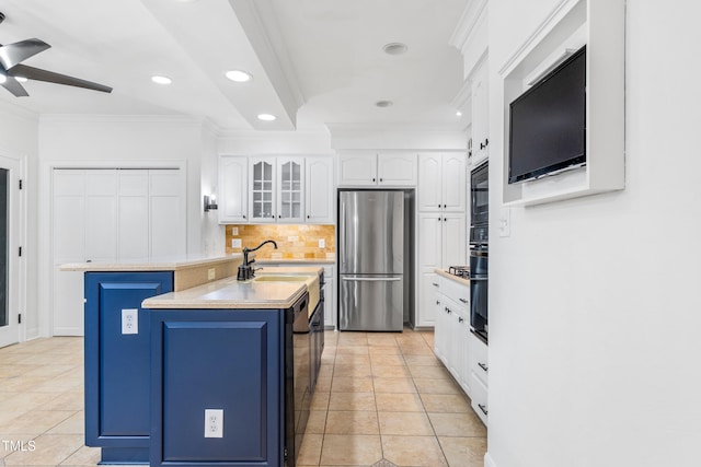 2205 Landings Way, Raleigh, NC 27615 - kitchen featuring freestanding refrigerator, blue cabinets, white cabinetry, light tile patterned floors, and crown molding