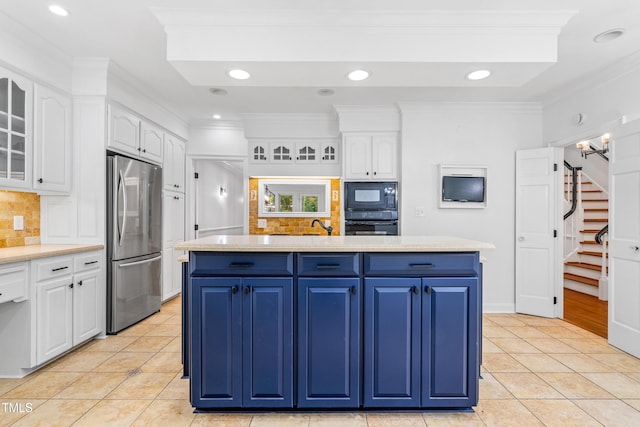 2205 Landings Way, Raleigh, NC 27615 - kitchen with stainless steel refrigerator, blue cabinets, a kitchen island, white cabinets, and crown molding