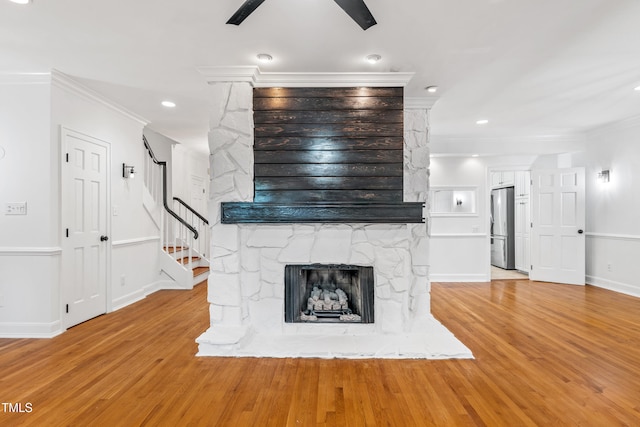 2205 Landings Way, Raleigh, NC 27615 - unfurnished living room with ornamental molding, light wood-style floors, stairway, a fireplace, and baseboards