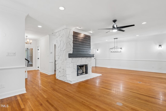 2205 Landings Way, Raleigh, NC 27615 - unfurnished living room featuring a chandelier, a fireplace, recessed lighting, crown molding, and baseboards