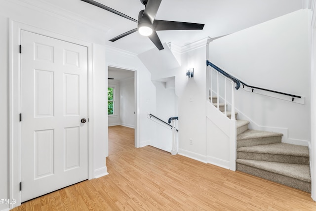 2205 Landings Way, Raleigh, NC 27615 - staircase featuring crown molding, a ceiling fan, wood finished floors, and baseboards