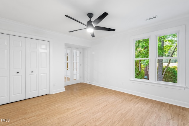 2205 Landings Way, Raleigh, NC 27615 - unfurnished bedroom with light wood-style floors, baseboards, crown molding, french doors, and ceiling fan