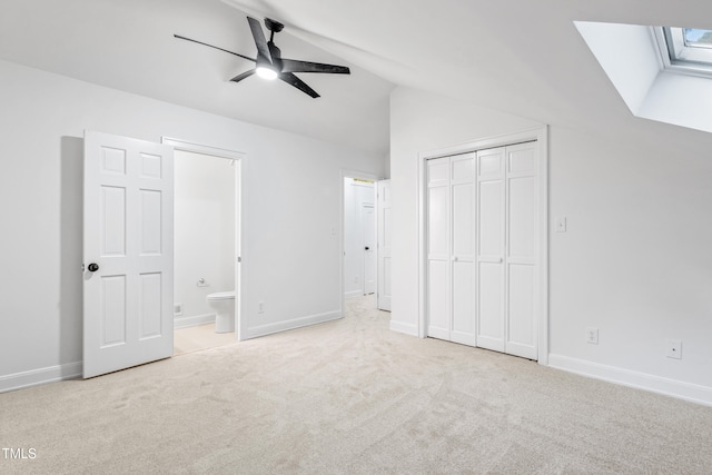 2205 Landings Way, Raleigh, NC 27615 - unfurnished bedroom featuring carpet, lofted ceiling, a closet, ensuite bathroom, and baseboards