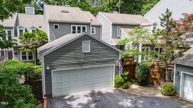 2205 Landings Way, Raleigh, NC 27615 - view of front of home with asphalt driveway, a garage, and roof with shingles