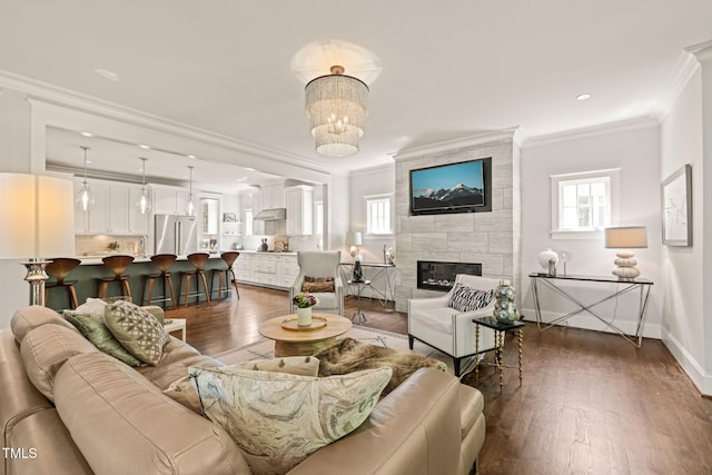 129 Ruskin Dr, Chapel Hill, NC 27516 - living area with healthy amount of natural light, ornamental molding, dark wood-style floors, a tiled fireplace, and baseboards