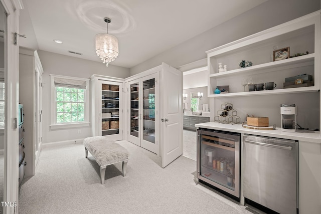 129 Ruskin Dr, Chapel Hill, NC 27516 - bar with beverage cooler, light carpet, decorative light fixtures, and stainless steel dishwasher
