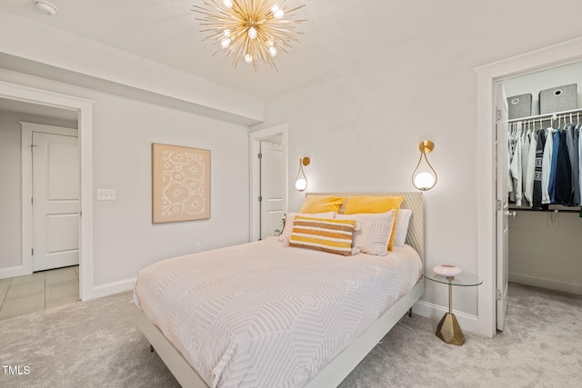 129 Ruskin Dr, Chapel Hill, NC 27516 - bedroom with carpet, a chandelier, a spacious closet, baseboards, and a closet