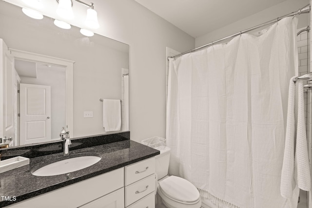 129 Ruskin Dr, Chapel Hill, NC 27516 - bathroom with toilet, vanity, and curtained shower