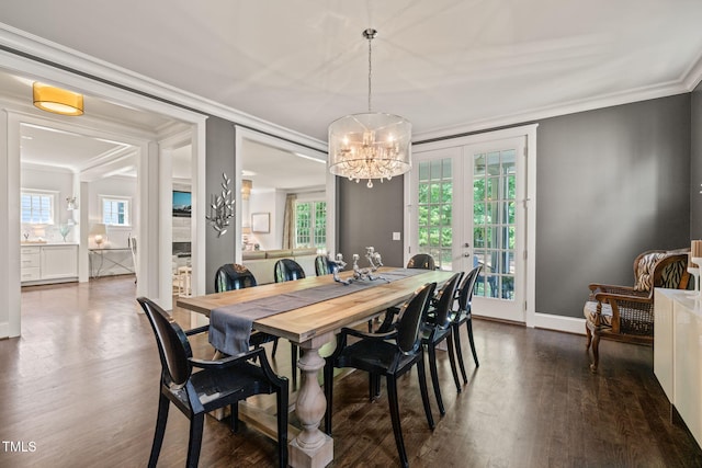 129 Ruskin Dr, Chapel Hill, NC 27516 - dining room featuring a chandelier, dark wood-style flooring, plenty of natural light, ornamental molding, and baseboards