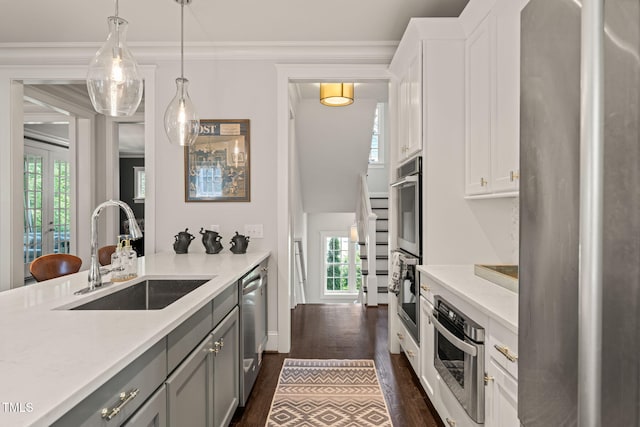 129 Ruskin Dr, Chapel Hill, NC 27516 - kitchen featuring a sink, dark wood-type flooring, gray cabinetry, stainless steel appliances, and light countertops