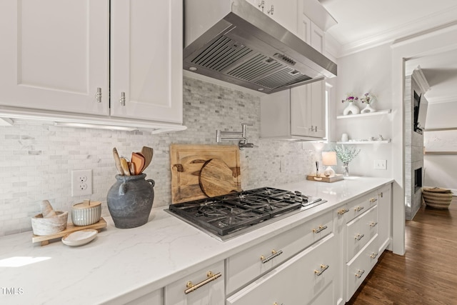129 Ruskin Dr, Chapel Hill, NC 27516 - kitchen featuring wall chimney exhaust hood, stainless steel gas stovetop, white cabinets, decorative backsplash, and ornamental molding
