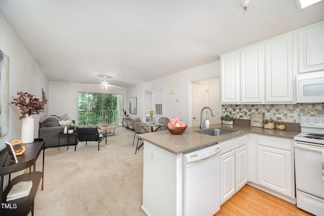 1851 Trailwood Heights Ln Unit 204, Raleigh, NC 27603 - kitchen with white appliances, open floor plan, a peninsula, and white cabinets