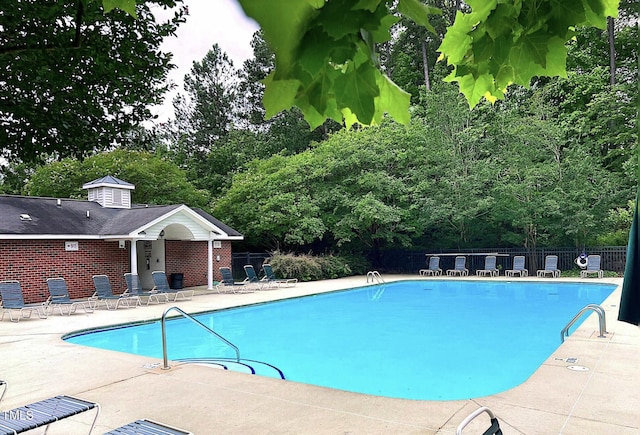 1851 Trailwood Heights Ln Unit 204, Raleigh, NC 27603 - community pool featuring a patio and view of wooded area