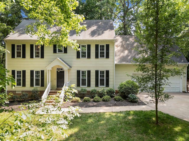 2840 Mattlyn Ct, Raleigh, NC 27613 - colonial home featuring driveway, an attached garage, and roof with shingles