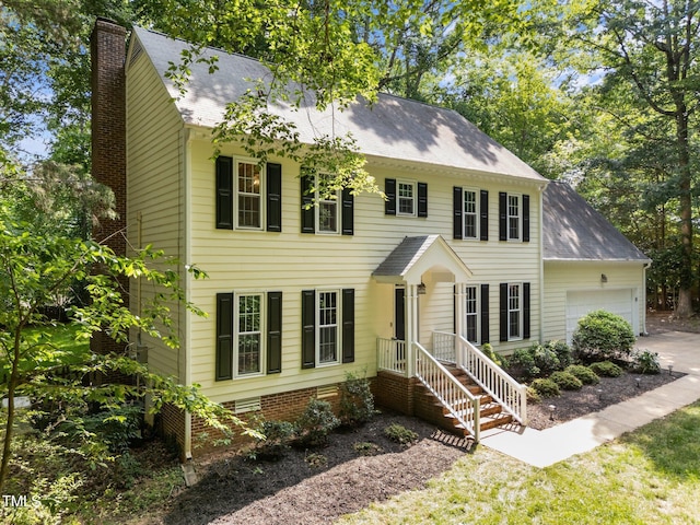 2840 Mattlyn Ct, Raleigh, NC 27613 - colonial-style house featuring an attached garage, a chimney, and roof with shingles