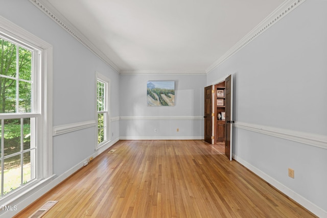 2840 Mattlyn Ct, Raleigh, NC 27613 - empty room featuring plenty of natural light, light wood-style flooring, baseboards, and ornamental molding