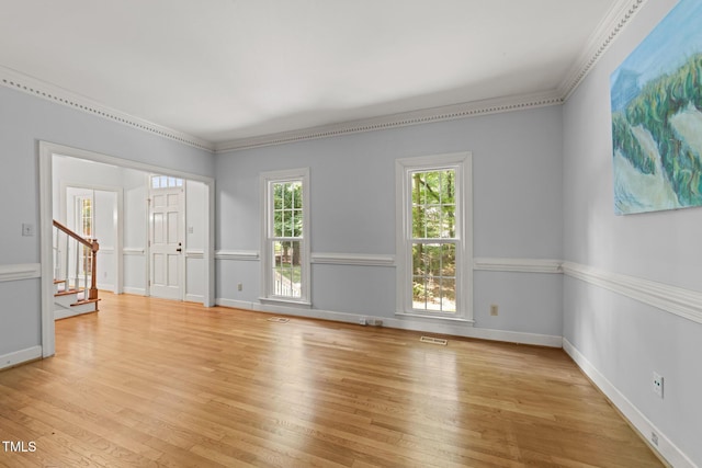 2840 Mattlyn Ct, Raleigh, NC 27613 - empty room with light wood-type flooring, stairs, crown molding, and baseboards