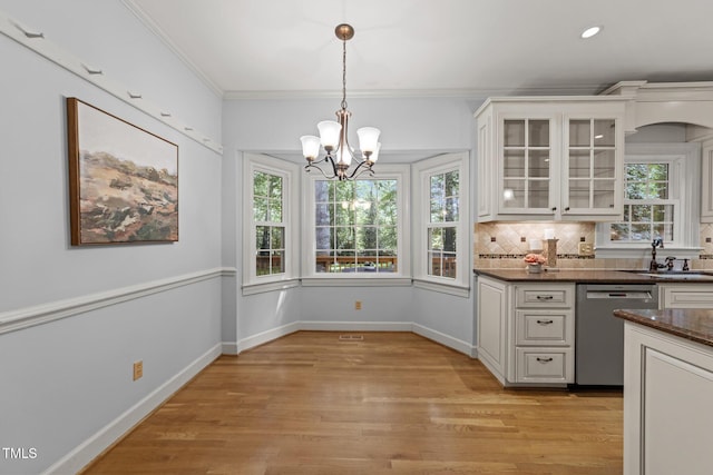 2840 Mattlyn Ct, Raleigh, NC 27613 - kitchen featuring dishwasher, a sink, healthy amount of natural light, white cabinets, and crown molding